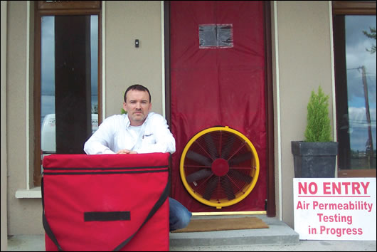 Pat Kyne of PK Energy Controls next to a blower-door Pat Kyne of PK Energy Controls next to a blower-door