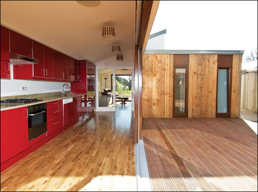 The galley kitchen is at the front of the extension and forms the western flank of the courtyard, leading into the living room The galley kitchen is at the front of the extension and forms the western flank of the courtyard, leading into the living room