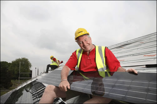 Tommy Walsh holding Nu-lock solar PV panels going into this 'ecohouse' project Tommy Walsh holding Nu-lock solar PV panels going into this 'ecohouse' project
